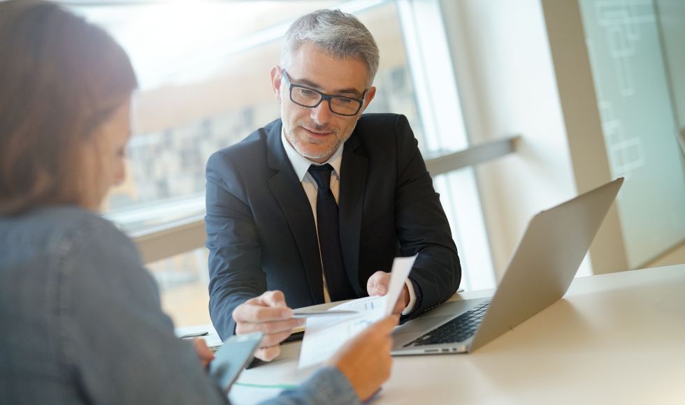 client with their accountant reviewing financial documents