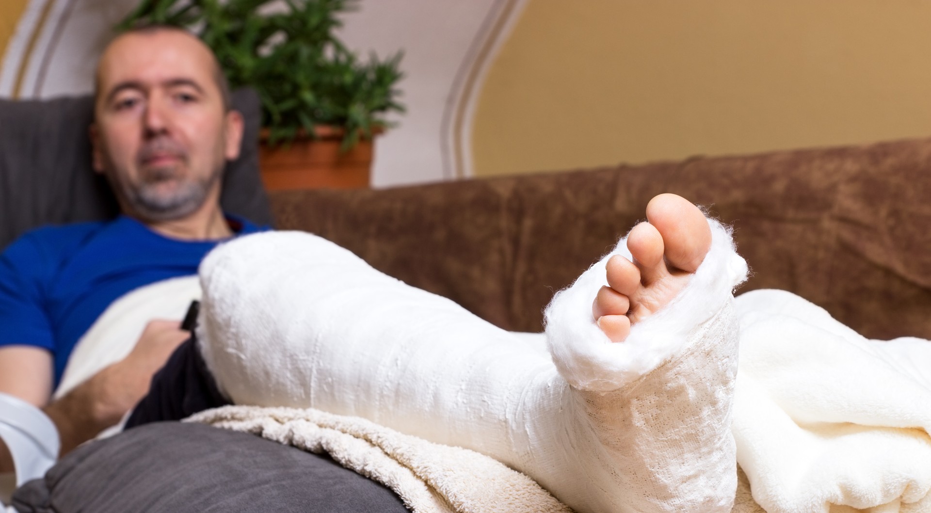 man lying in bed not able to work