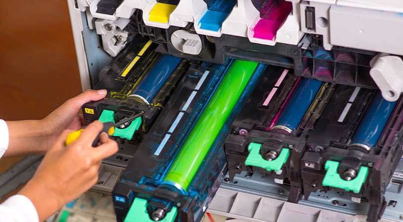 person reloading cartridge in photocopier