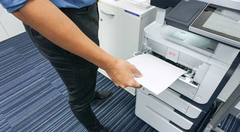 Man taking paper from printer