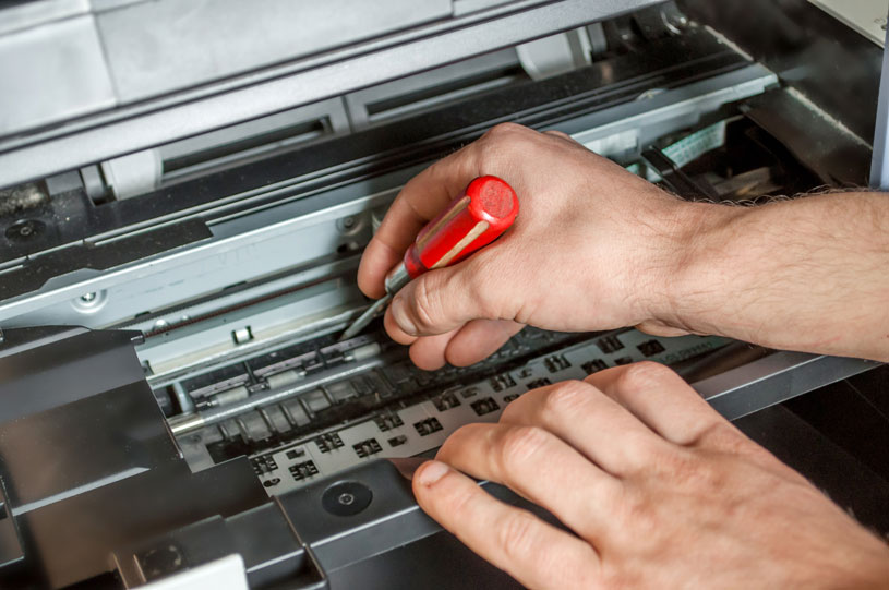 man repairing photocopier