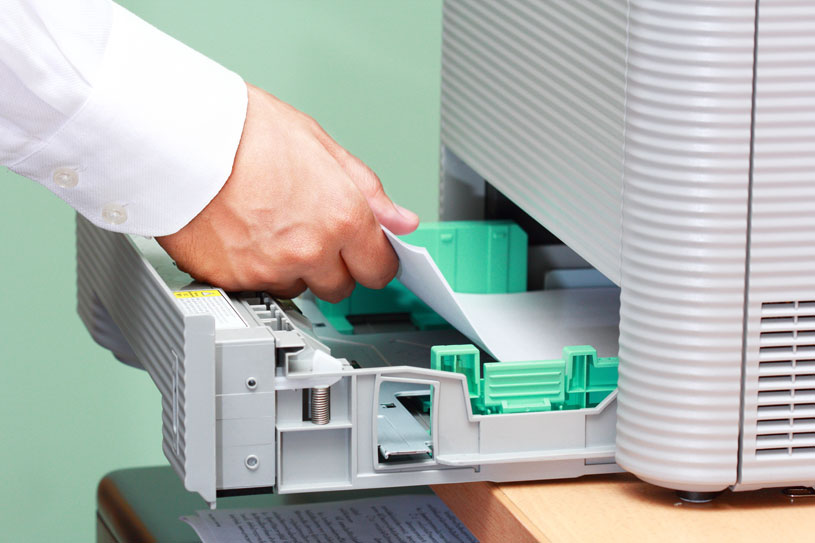man loading photocopier