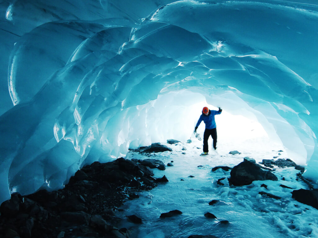 Woman in swimsuit on a swing in tropical location.