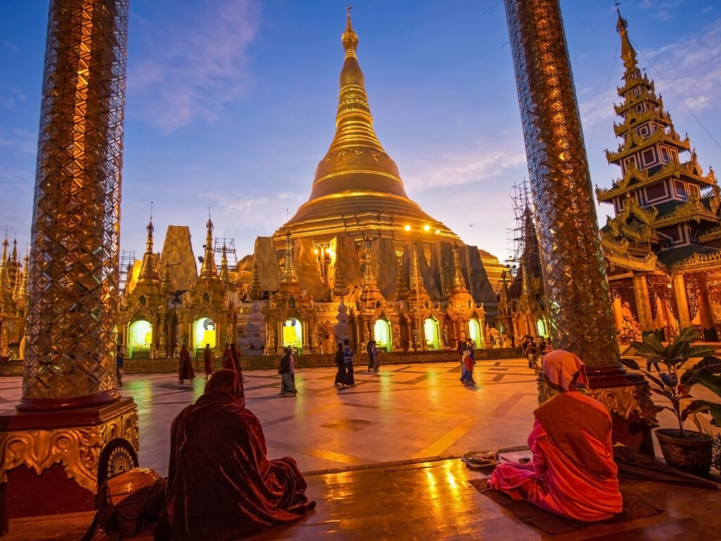 Woman in swimsuit on a swing in tropical location.