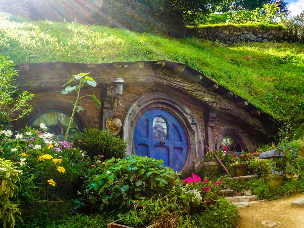 Woman in swimsuit on a swing in tropical location.