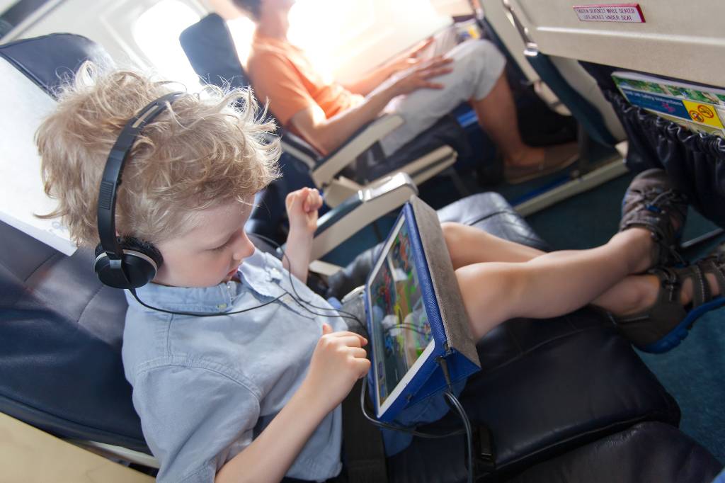 kid watching ipad on plane
