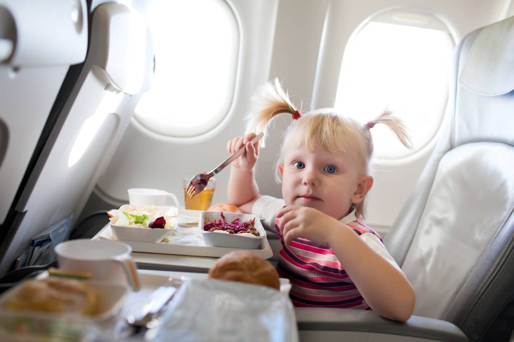 child eating on a plane