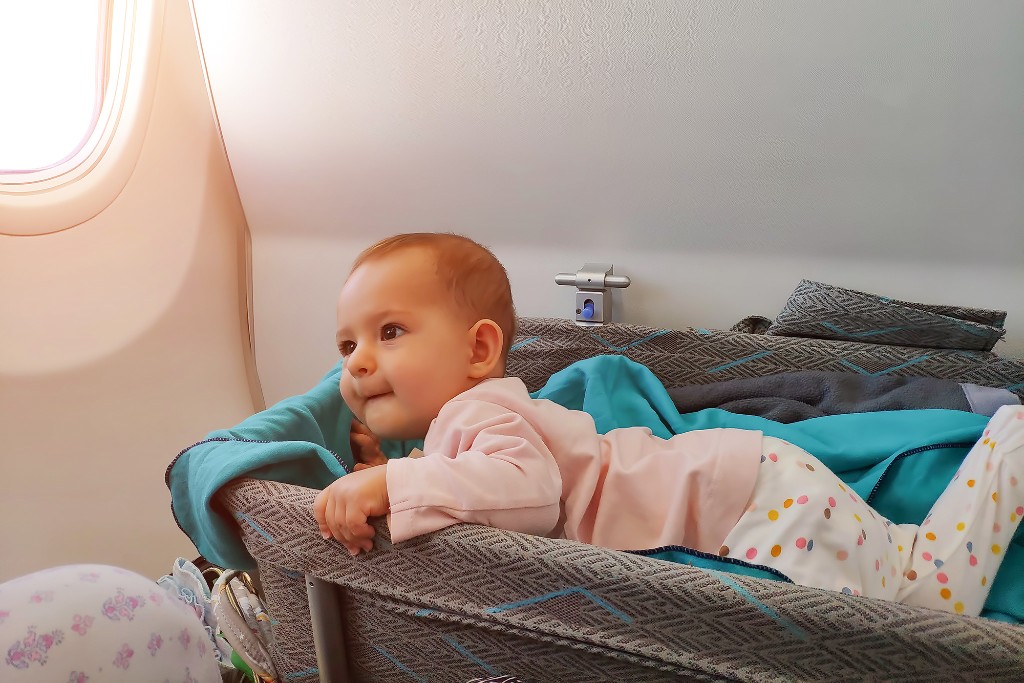 baby in airplane bassinet
