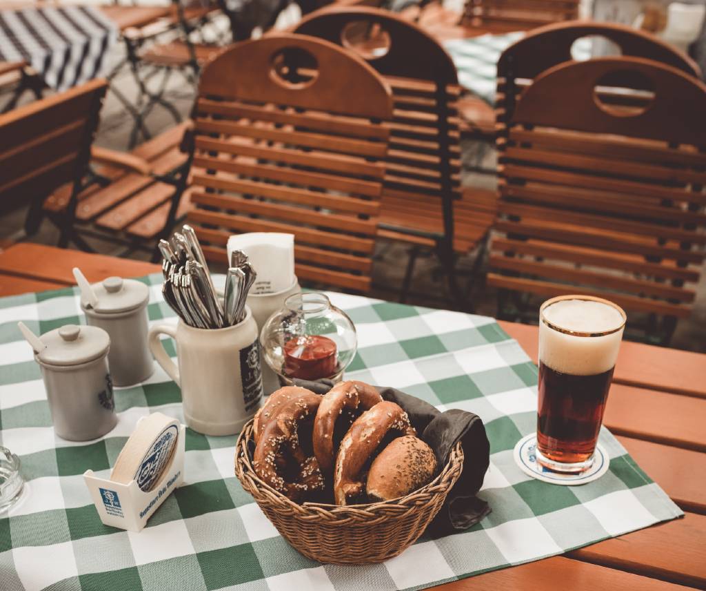 pretzels and beer on table in Munich beer garden