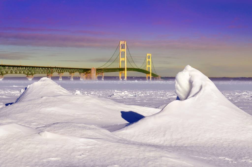 snowdrift with a backdrop of the Mackinac Bridge.