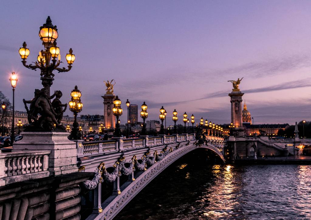 Paris bridge lit at night.