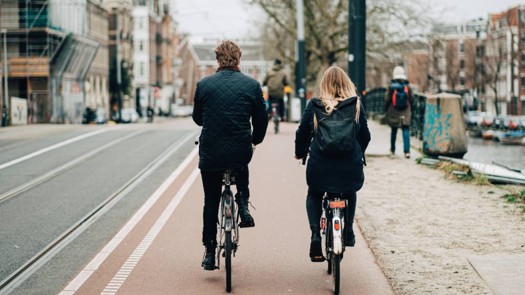couple biking in Amsterdam.