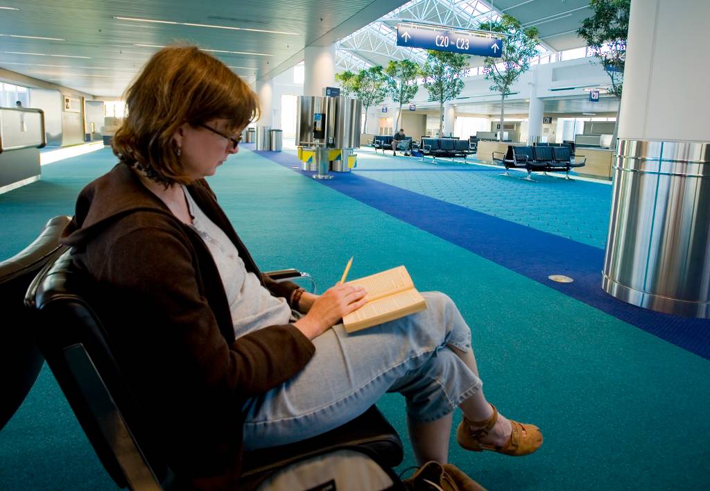 woman reading at the portland airport.