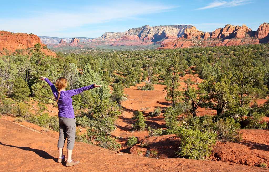 hiker admiring the view with arms outstretched in Sedona