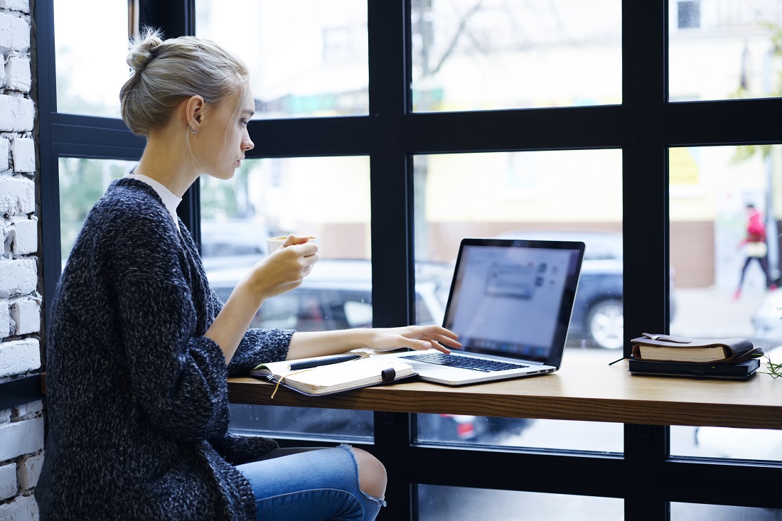 Young Woman Working from Coffee Shop