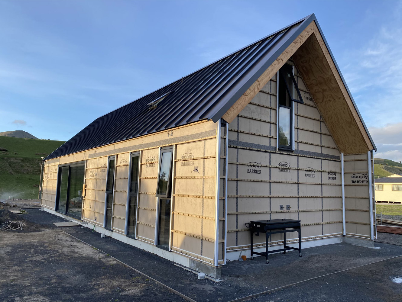 A photo of a house in the process of being built with a gabled roof