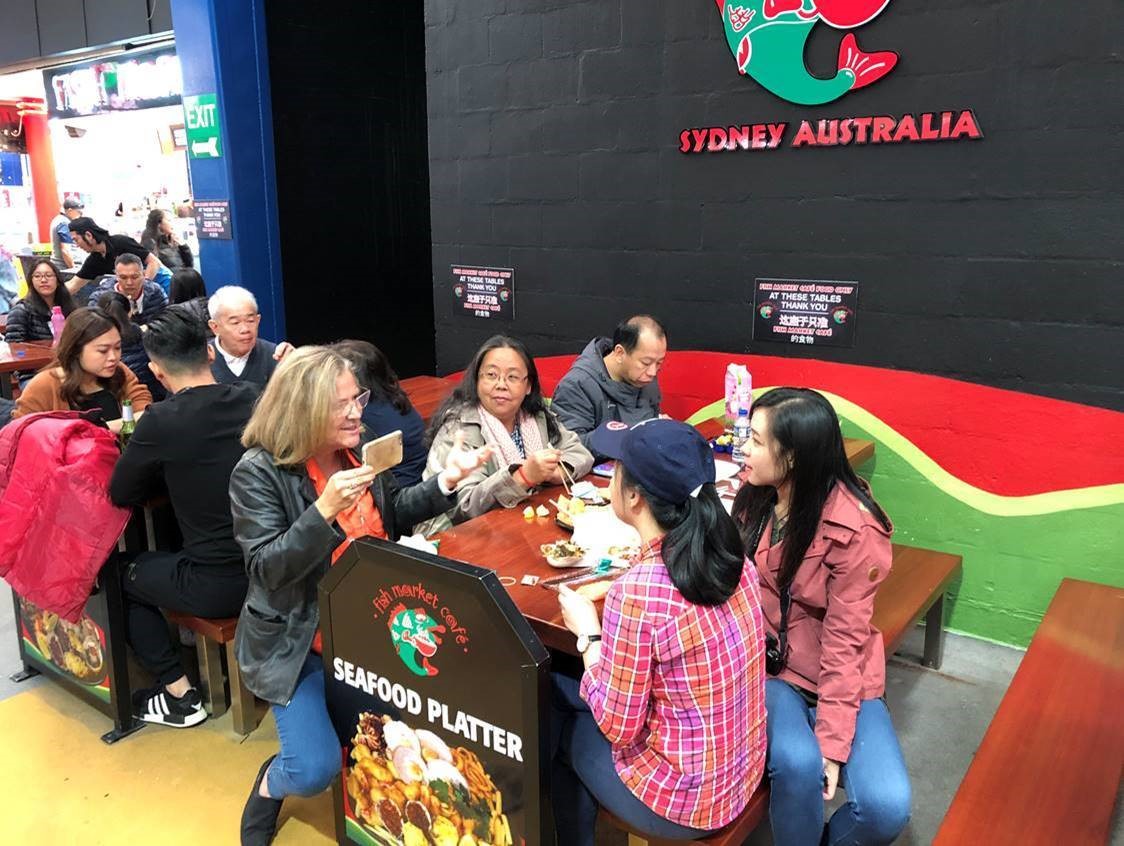 Mara Bun talks with Sydney Fish Market customers