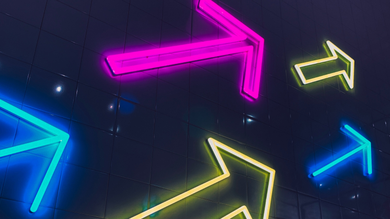 Different neon arrows in blue, yellow and magenta