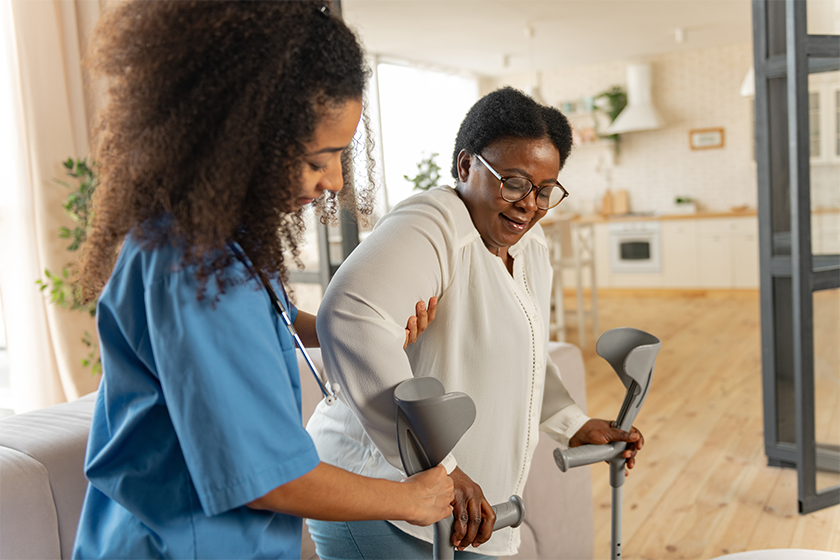 CareRev nurse helping patient walk