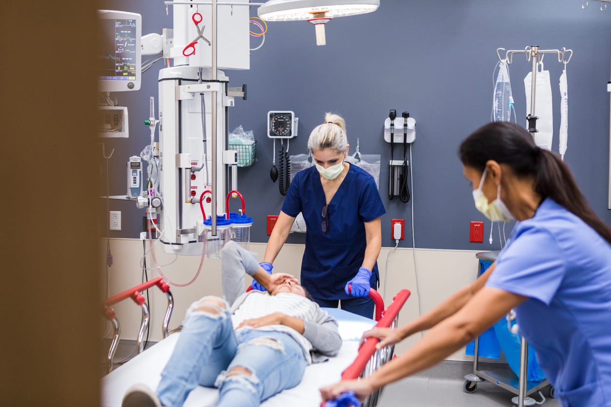 Triage nurses assess a patient who just arrived at the emergency room.