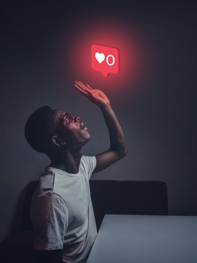 man looking at instagram like light