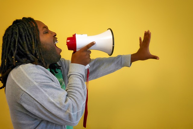 man speaking in megaphone about creating an app