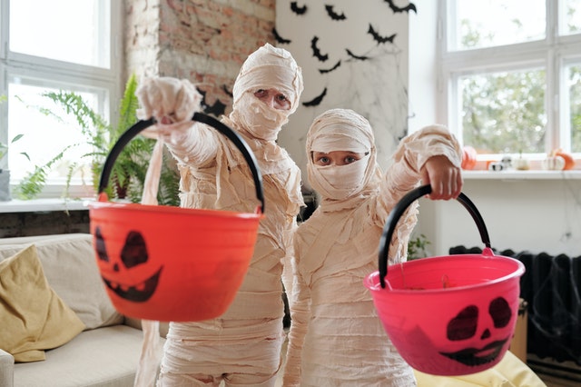 two people in mummy halloween costumes