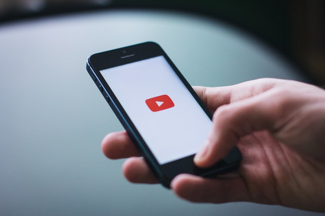 person watching youtube videos on phone