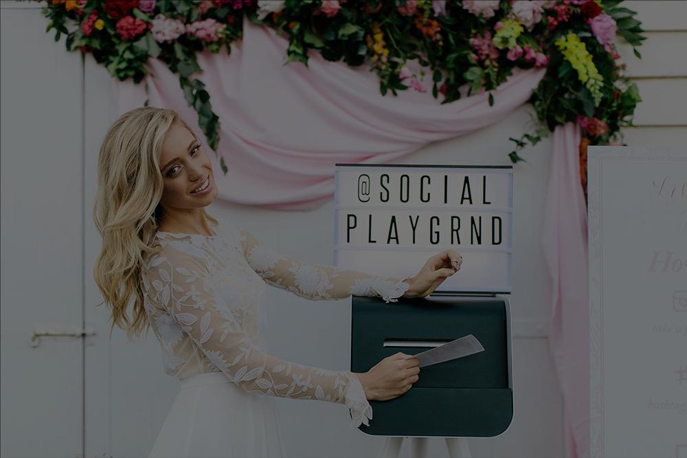 girl at wedding taking instagram print from instagram printer