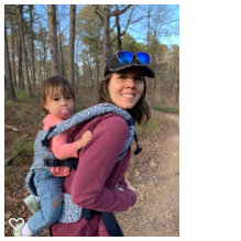 Toddler in a secure harness on mom's back while they are hiking