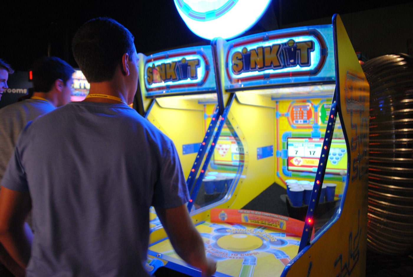 adult playing arcade game