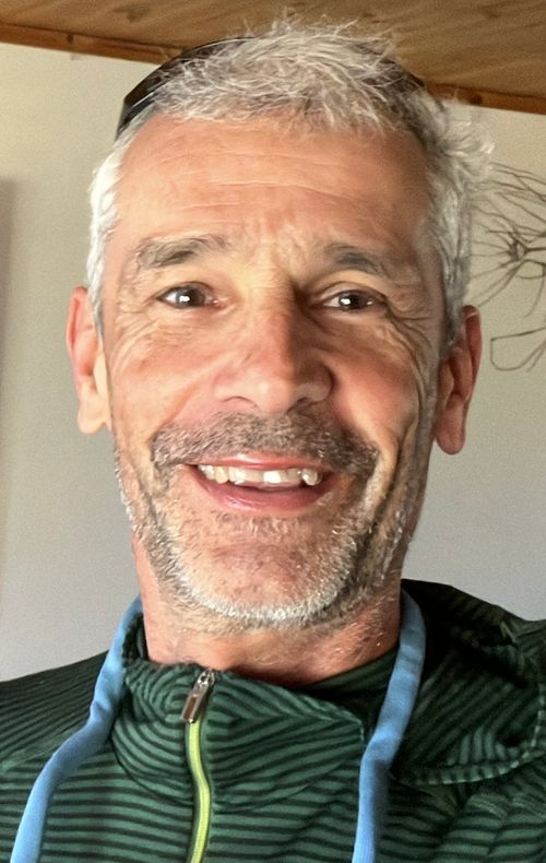 Marc Stahli standing with home plans