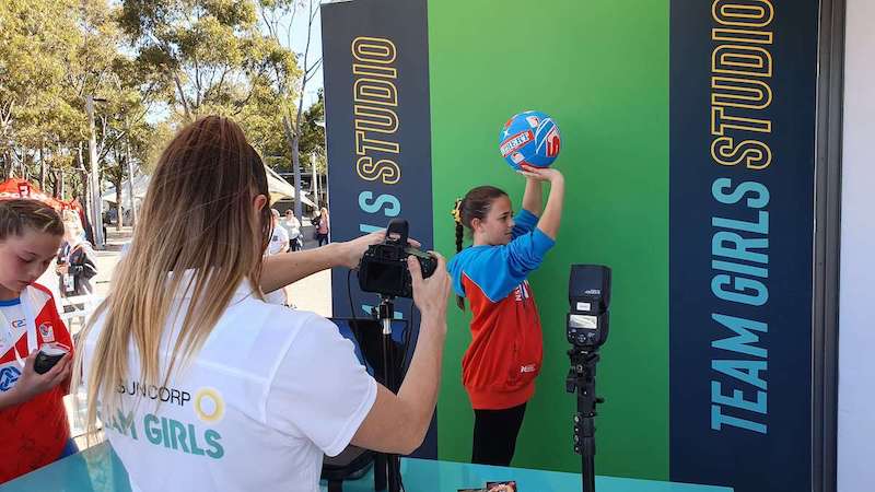 event staff taking photo of people at green screen event