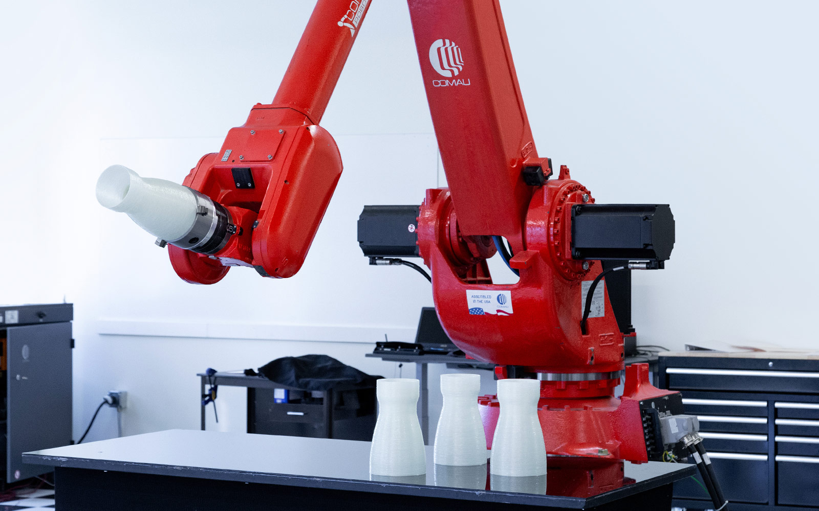 NJ130 Comau robot holding fiberglass de laval nozzle.