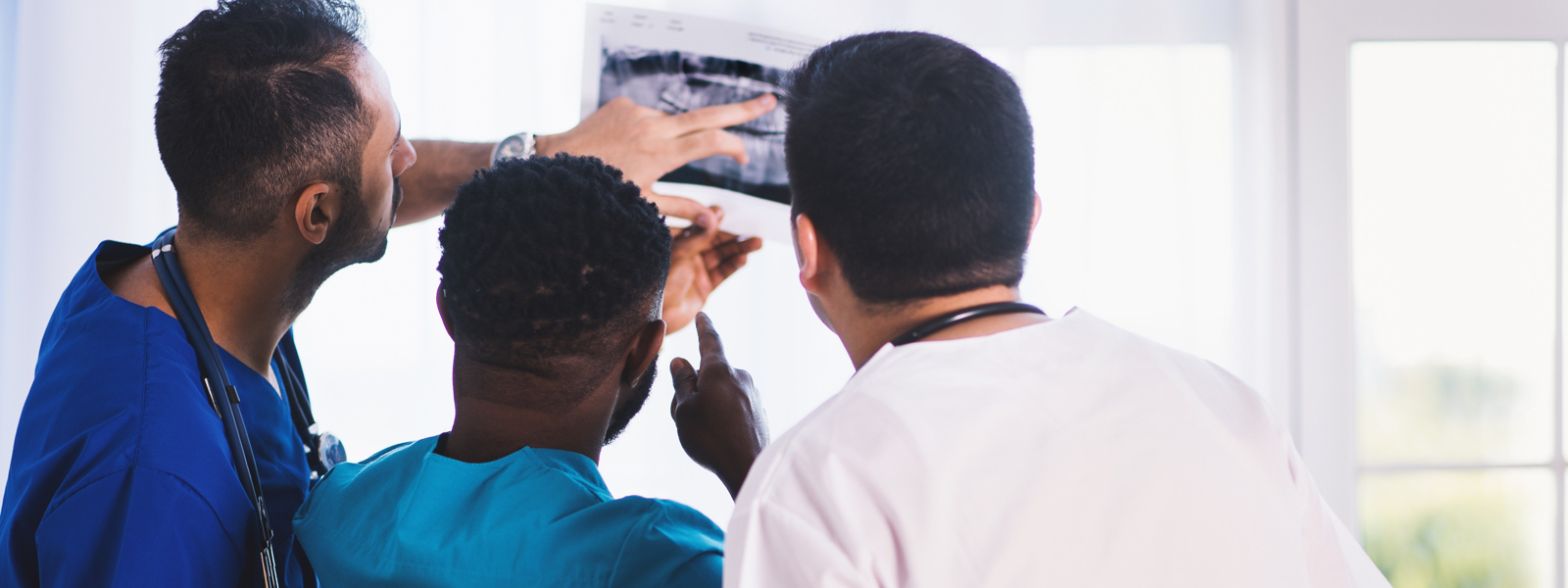 three nurses looking at x-ray new grad residency program nursing school
