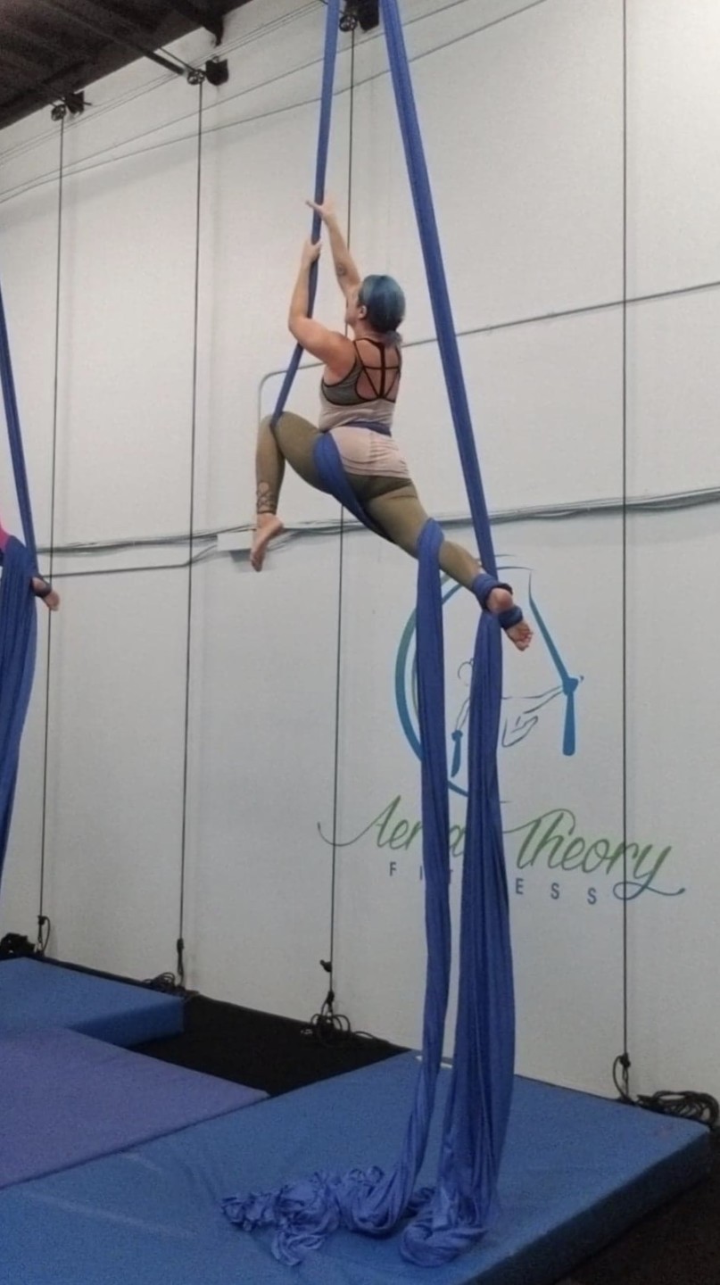 nurse ashley bowlin hanging from acro yoga ribbons