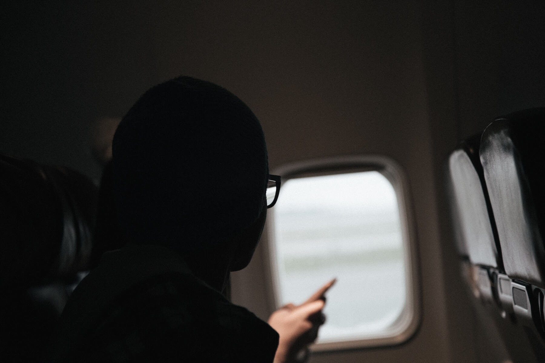 travel nursing for the firs time woman on plane looking out of window