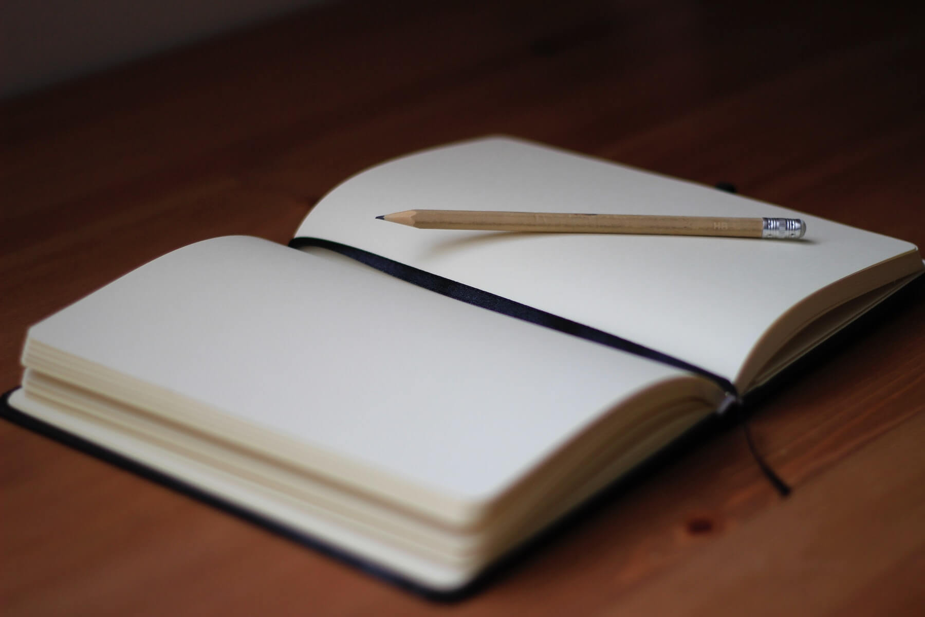 open journal it pencil on wooden table journaling compassion fatigue in nursing
