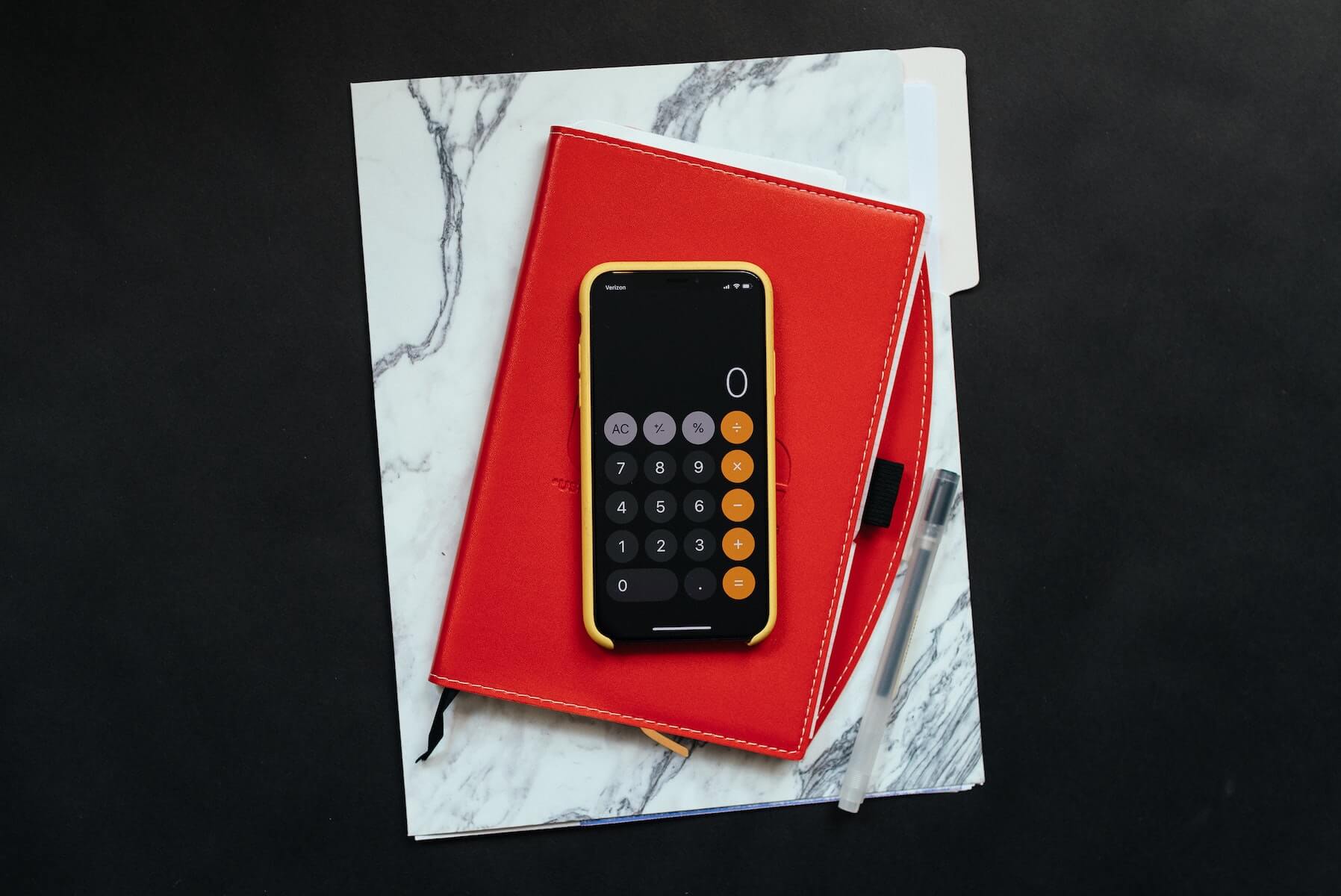 phone on top of notebook and papers financial donations covid19 how to help