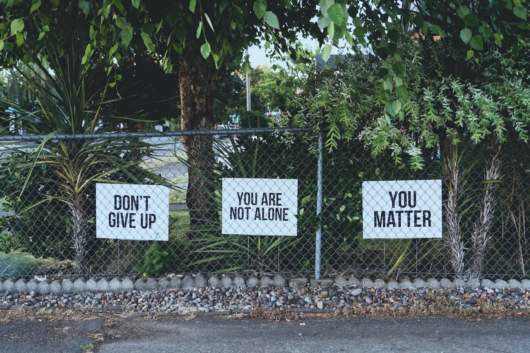 photos of motivational signs on fence mental health awareness month OSU trusted health mental health partnership