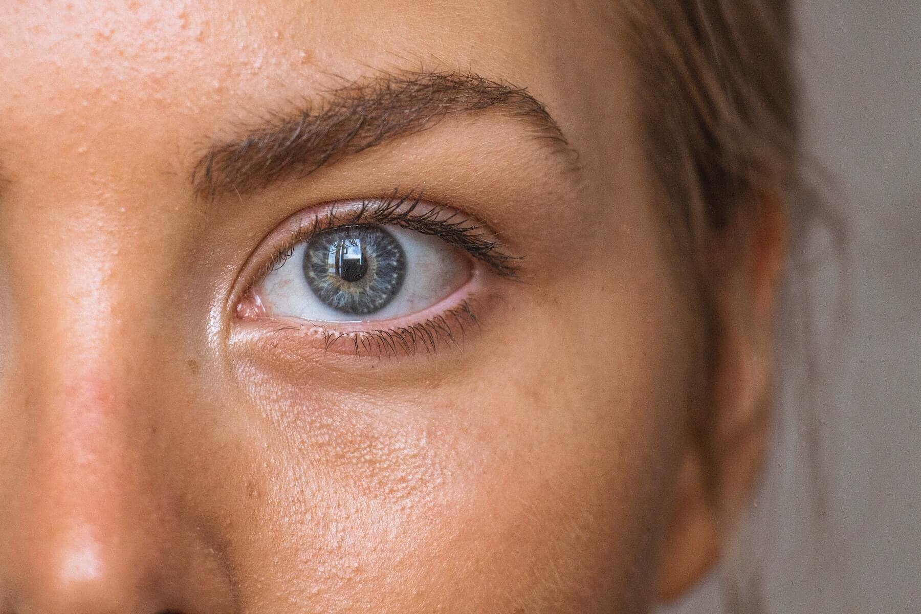 closeup of one side of woman's face staring into camera nurse skinscare