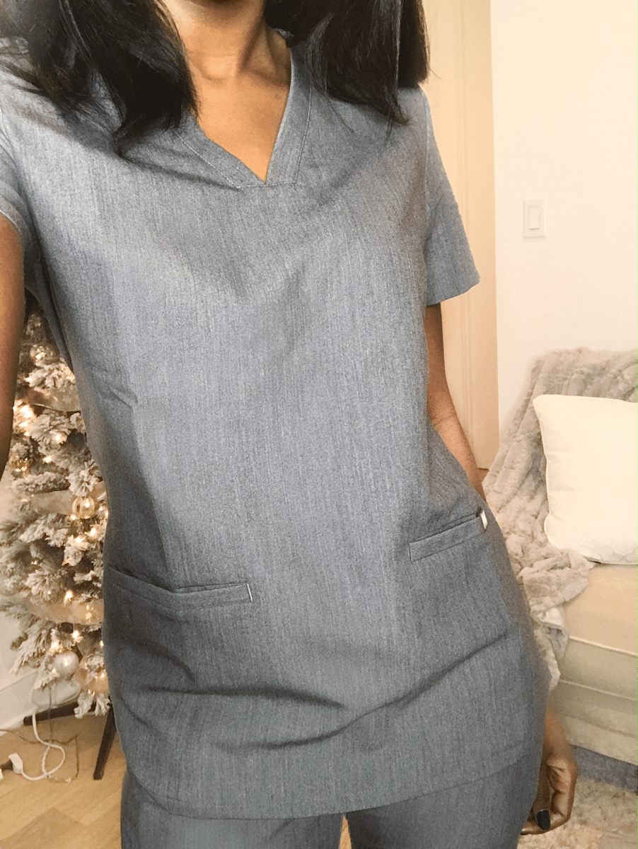 woman posing in scrubs showing scrubs top figs scrubs review