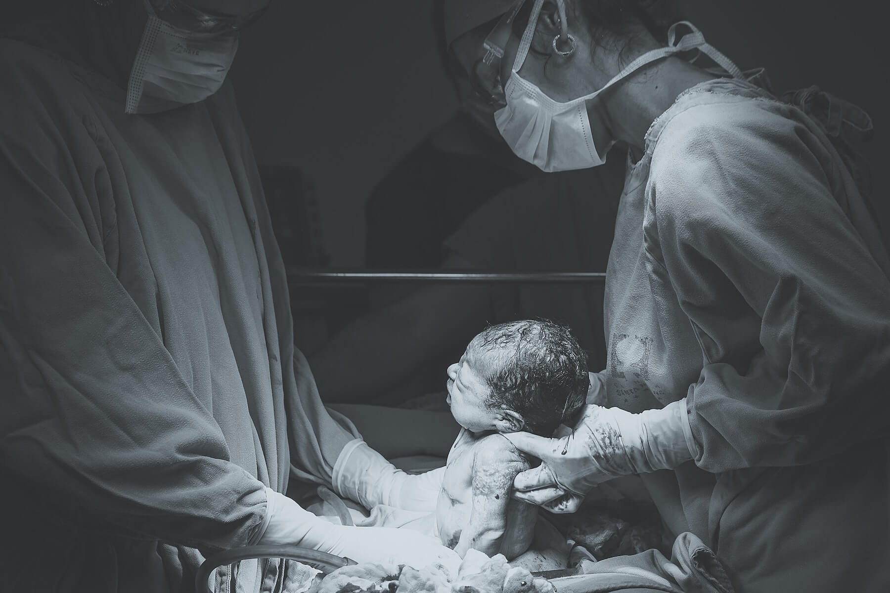 two nurses delivering a baby certified nurse midwife cnm