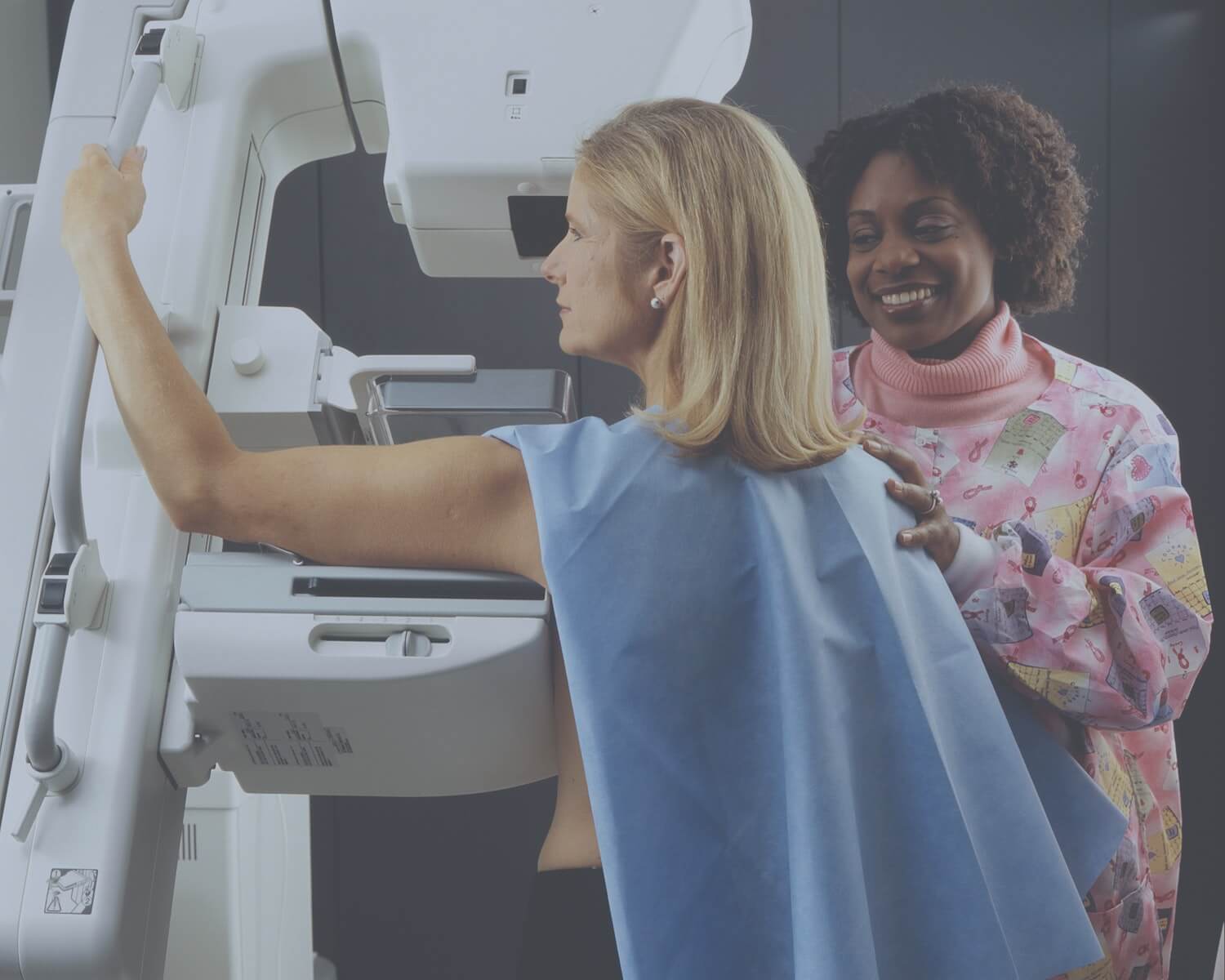 woman getting mammogram with nurse in background oncology nursing