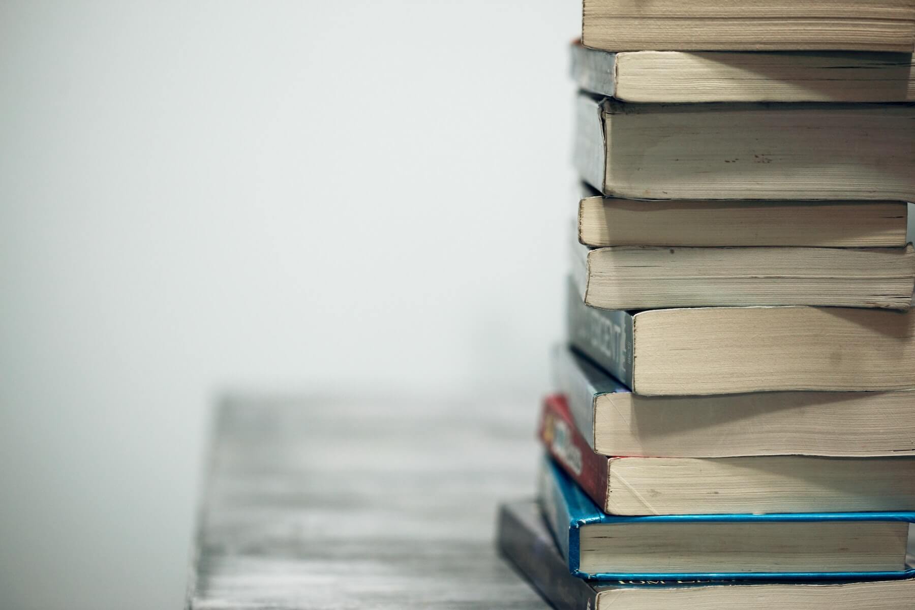 stack of thick text books clinical nurse educator