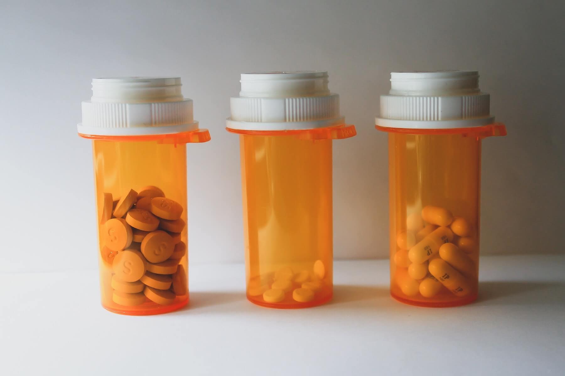 three orange plastic pill bottles standing side by side psychiatric nurse practitioner mental health