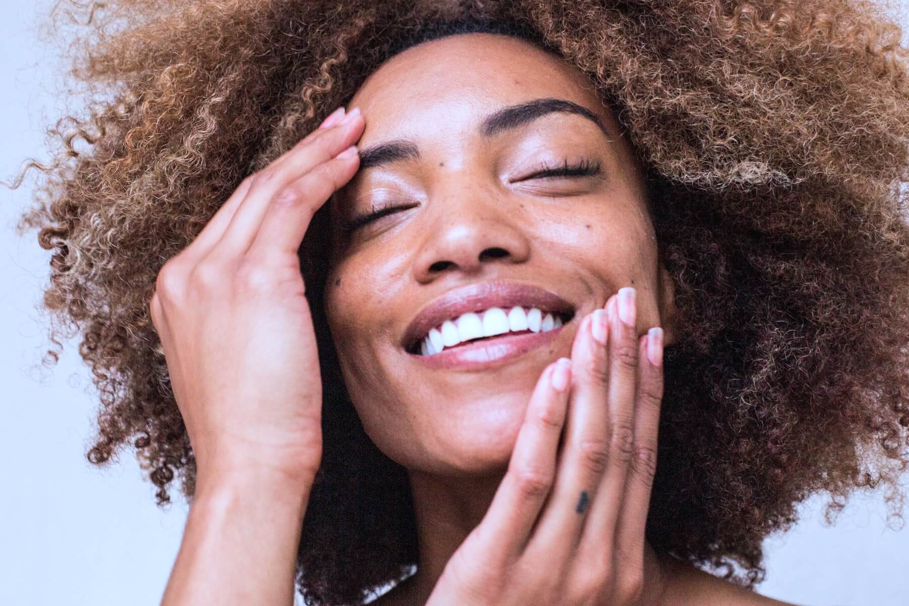 woman touching face with hands nurse skincare
