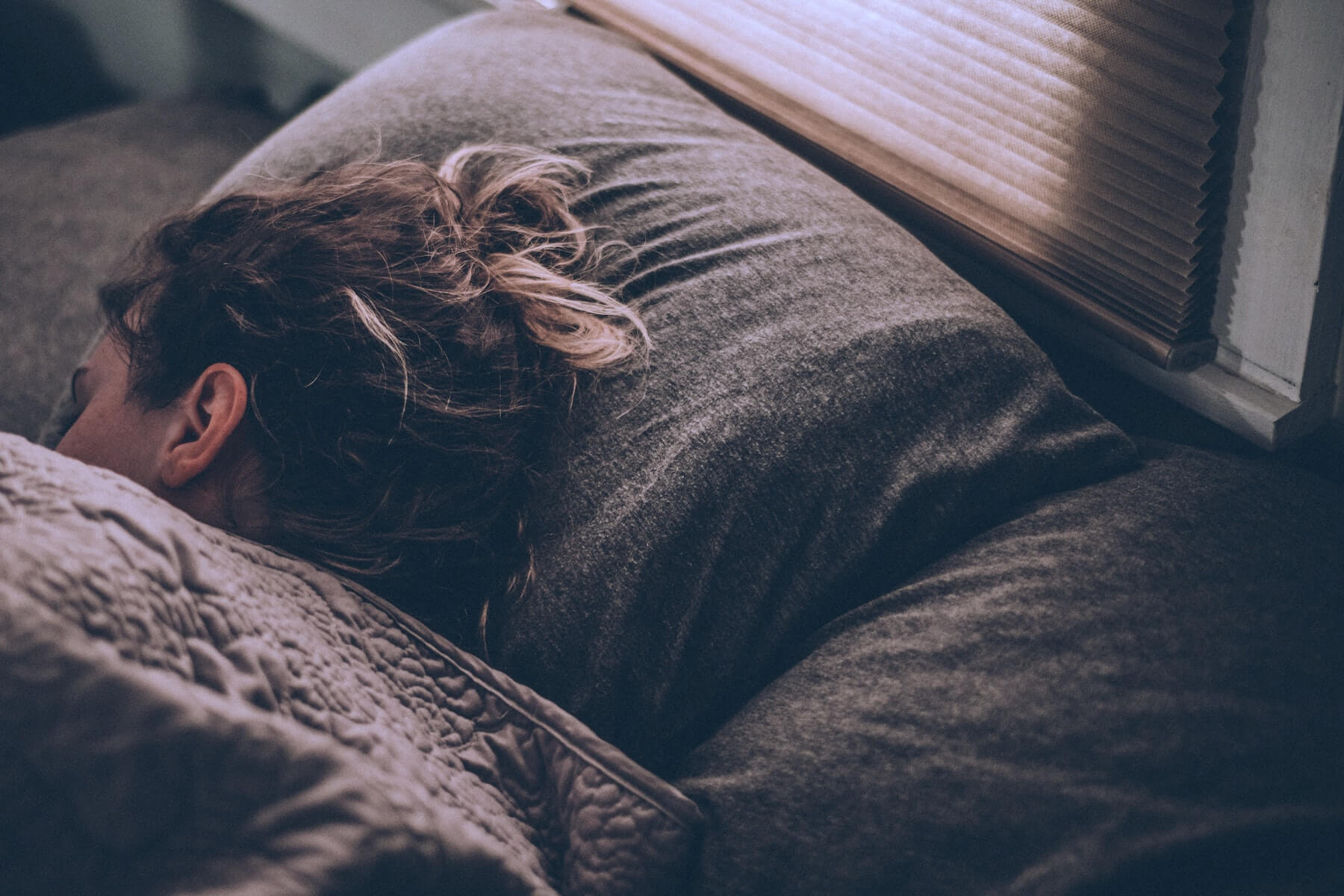 woman lying sideways in bed asleep nurse sleep
