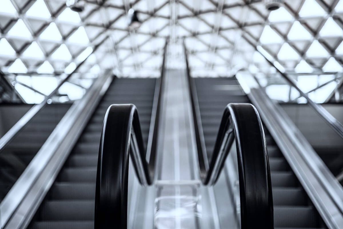 airport escalator view looking up how to become a travel nurse