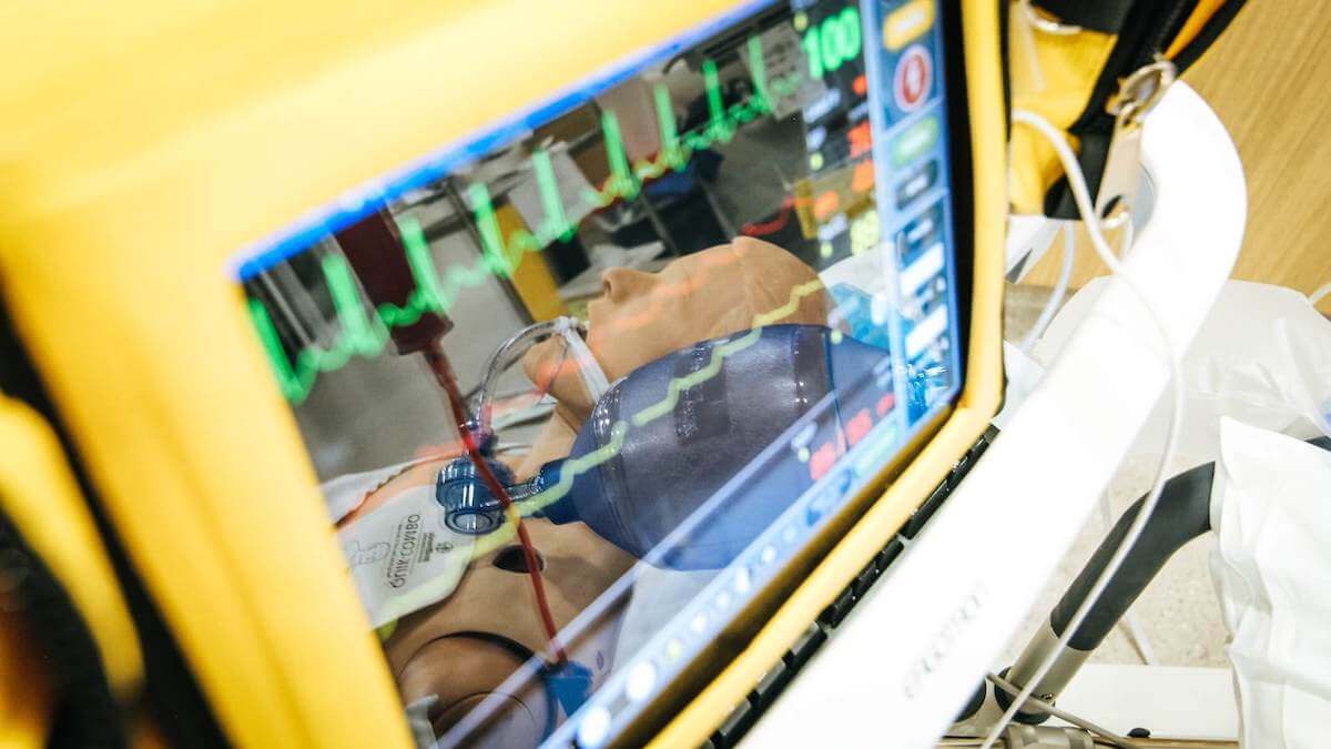 reflection of healthcare model in pulse machine display cardiac care nurse